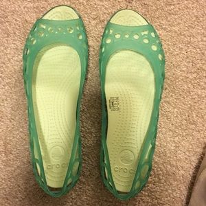 Mint green Crocs sandals.
